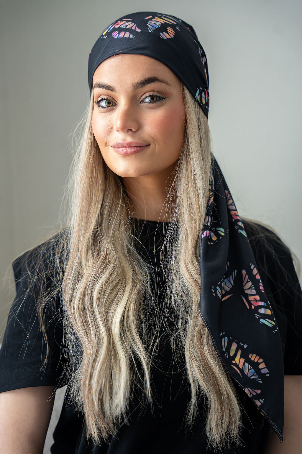Black headscarf featuring soft pink and burgundy blooms.