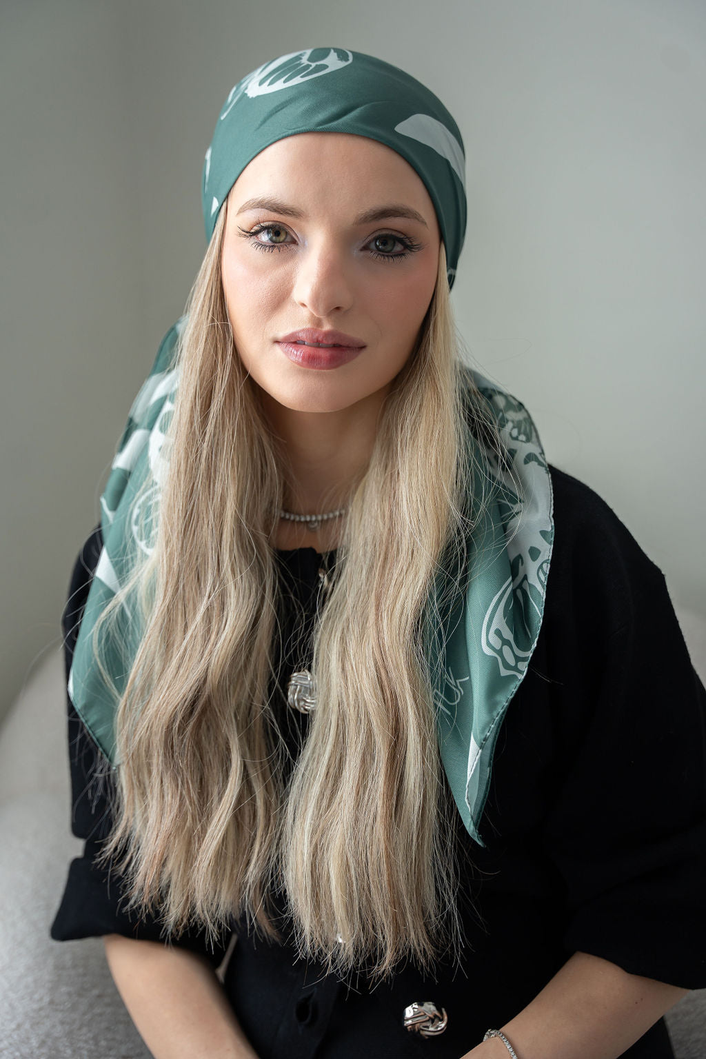 Moss green, soft cream, and hints of muted olive or bark brown.