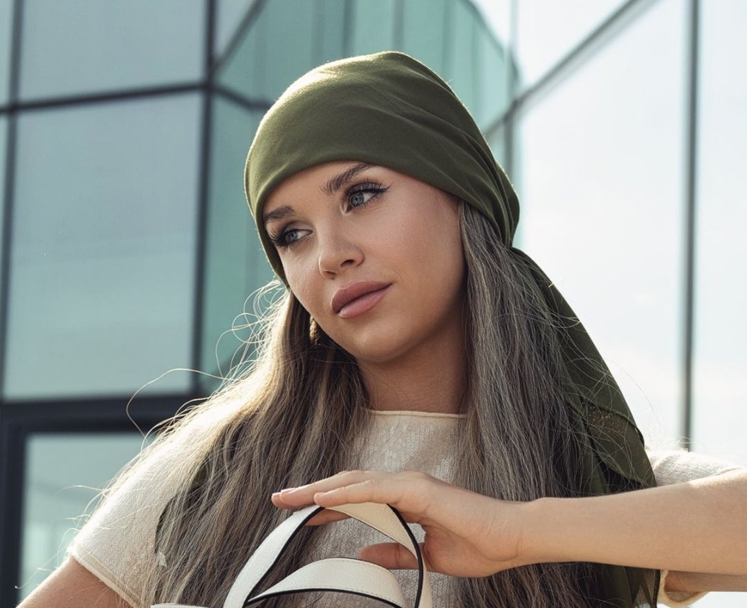 Model wearing an olive green TUK headscarf 