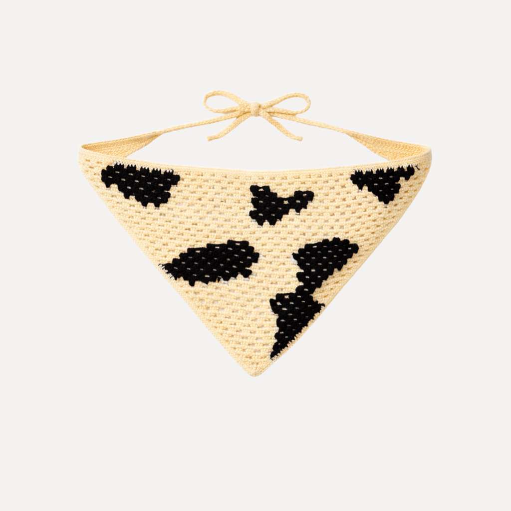 Cow print crochet bandana by TUK featuring black and cream calf hair pattern, handmade boho western style tie-up headscarf accessory.