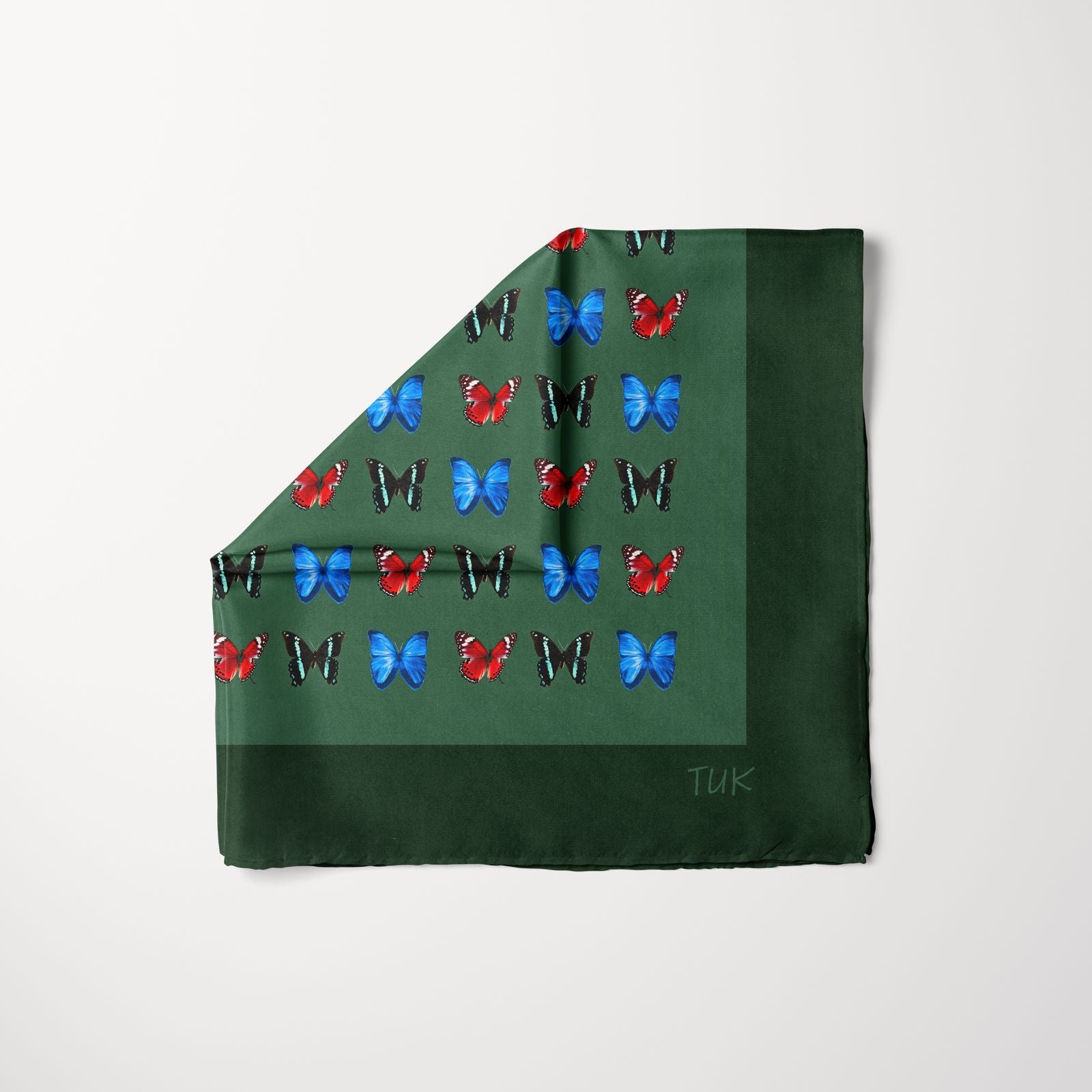 TUK Camofly Pre-tied Head Scarf in deep green with bold red, blue, and black butterfly patterns for a vibrant, nature-inspired style.
