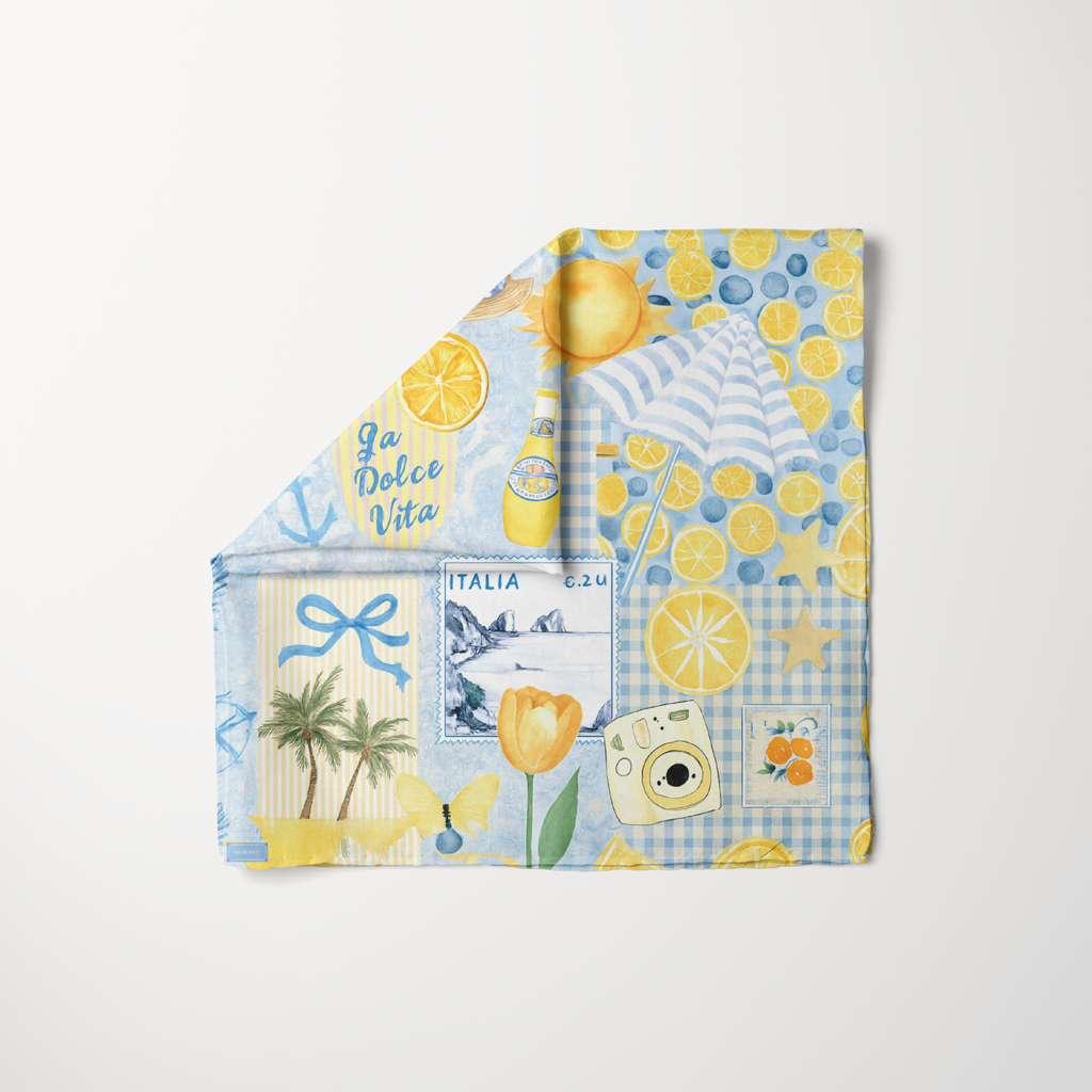 Tie Ur Knot Ciao For Now head scarf with lemon print, Italian coastal motifs, sun, umbrella, and blue-yellow summer pattern.