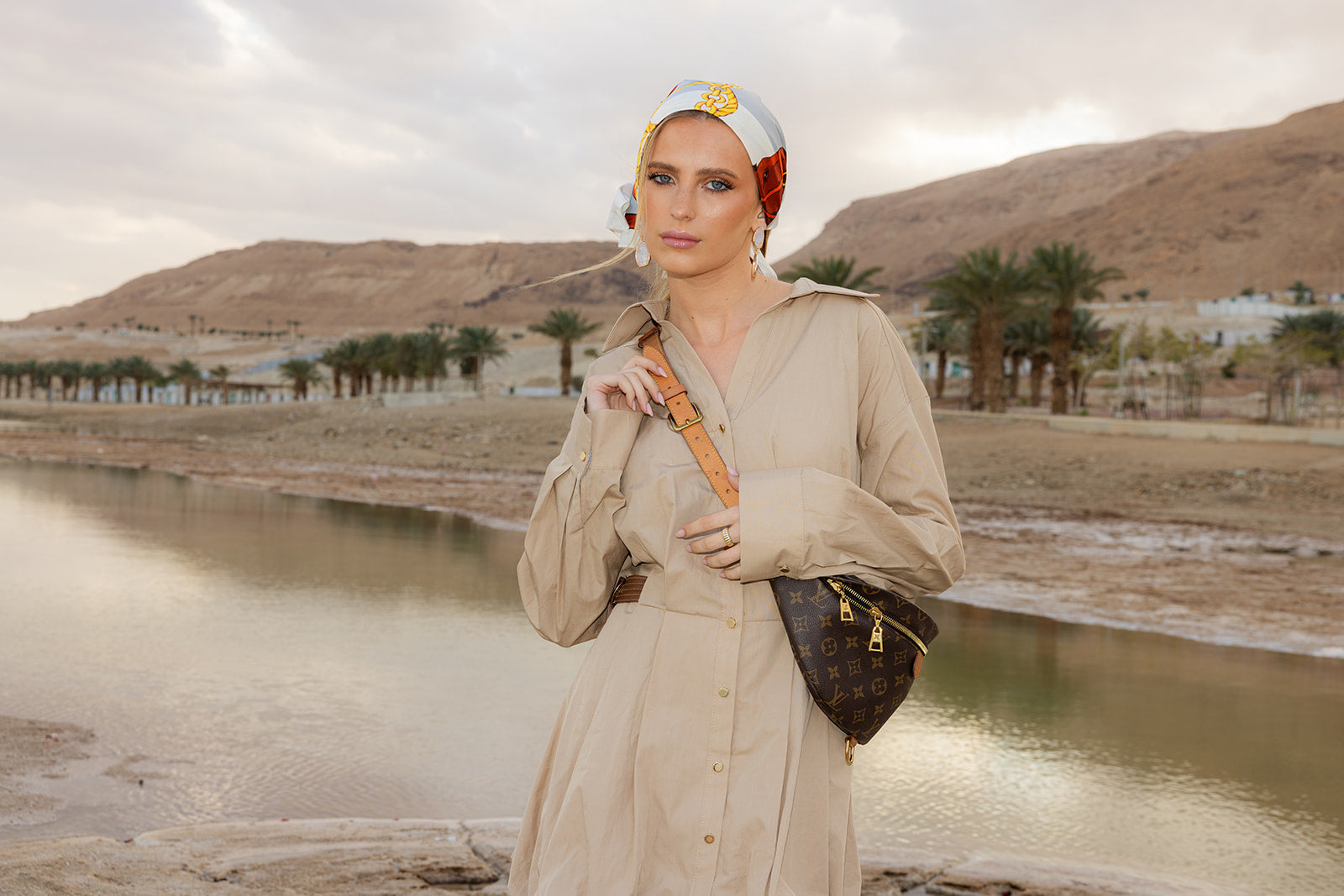 TUK Cool Reins Silk Bandana with elegant equestrian print styled as a silk headscarf, paired with a beige dress outdoors.