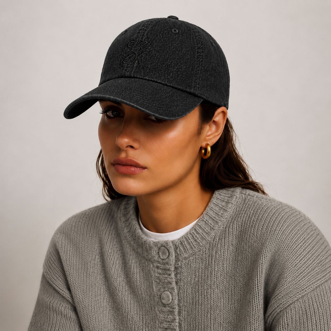 Model wearing TUK Dark Wash Denim Cap in black denim with tonal embroidered logo, curved brim, and timeless casual style.