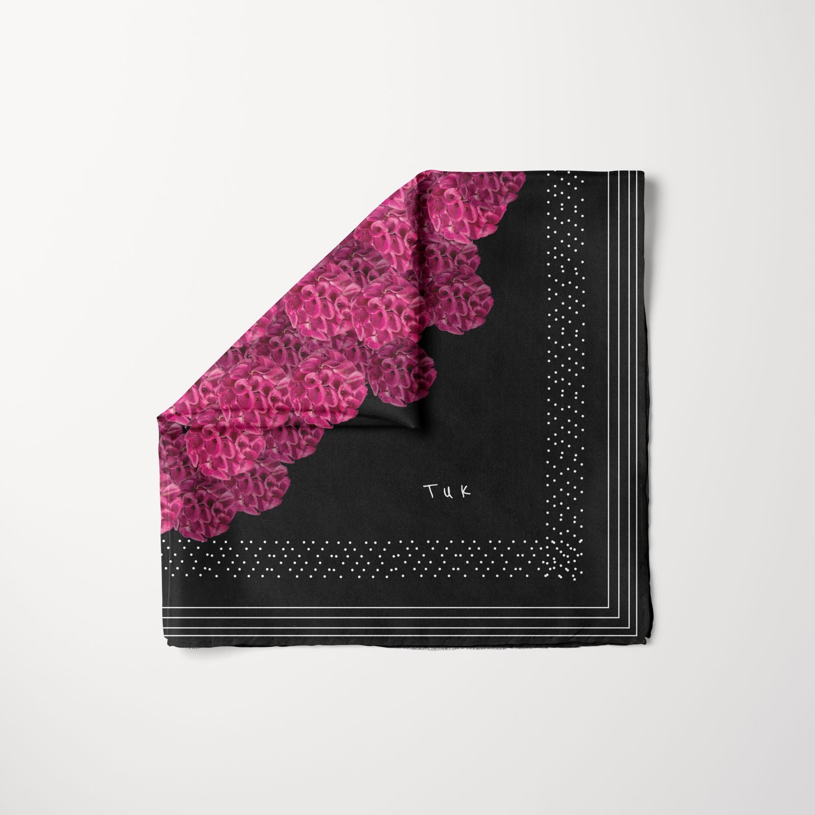 TUK Decollective Head Scarf featuring bold black fabric with vibrant magenta floral accents, dotted borders, and sleek modern lines.