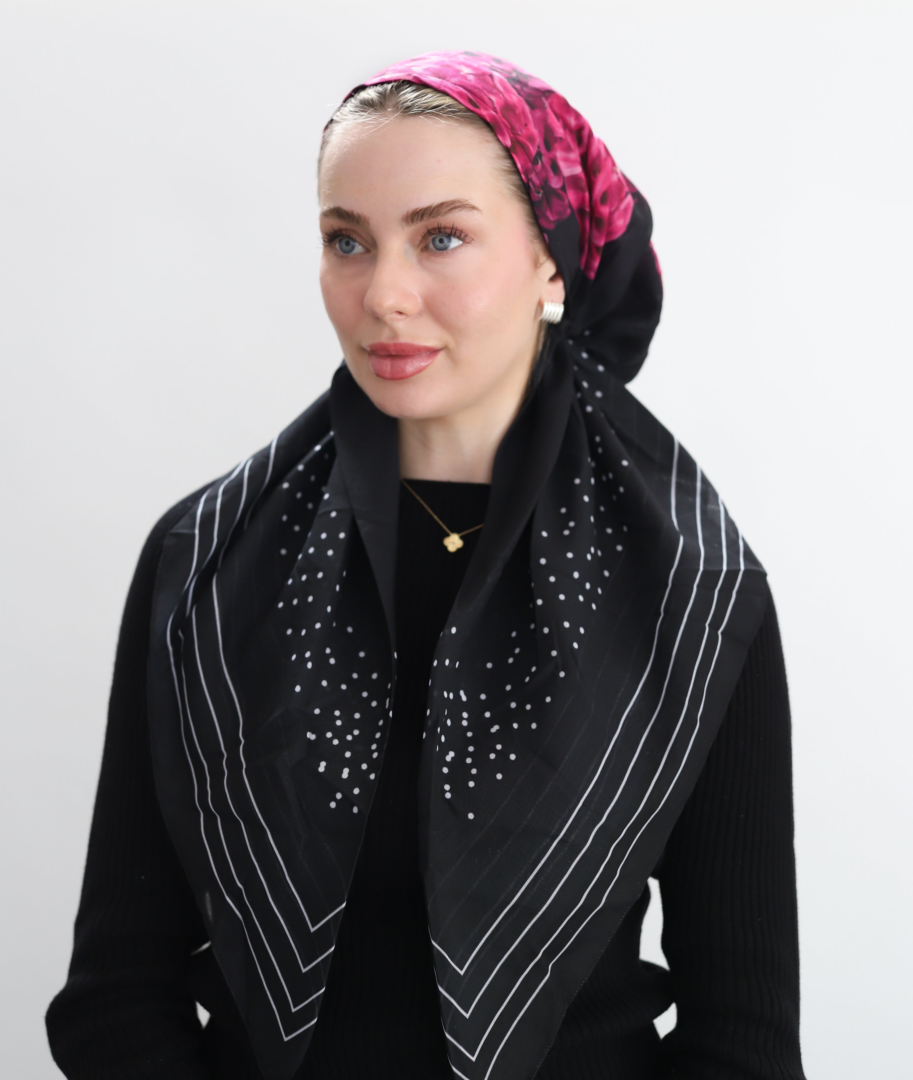 Woman wearing  TUK Decollective Pre-tied Head Scarf showcases a bold interplay of structure and artistry. 