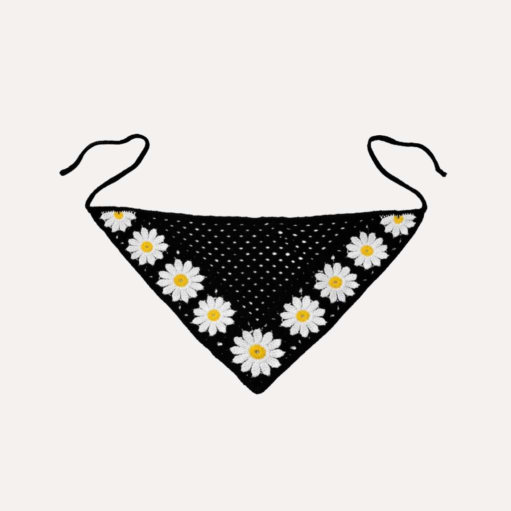 Black crochet triangle bandana with white daisy flowers, handmade Fleur Crochet Bandana by TUK, boho floral headscarf accessory.