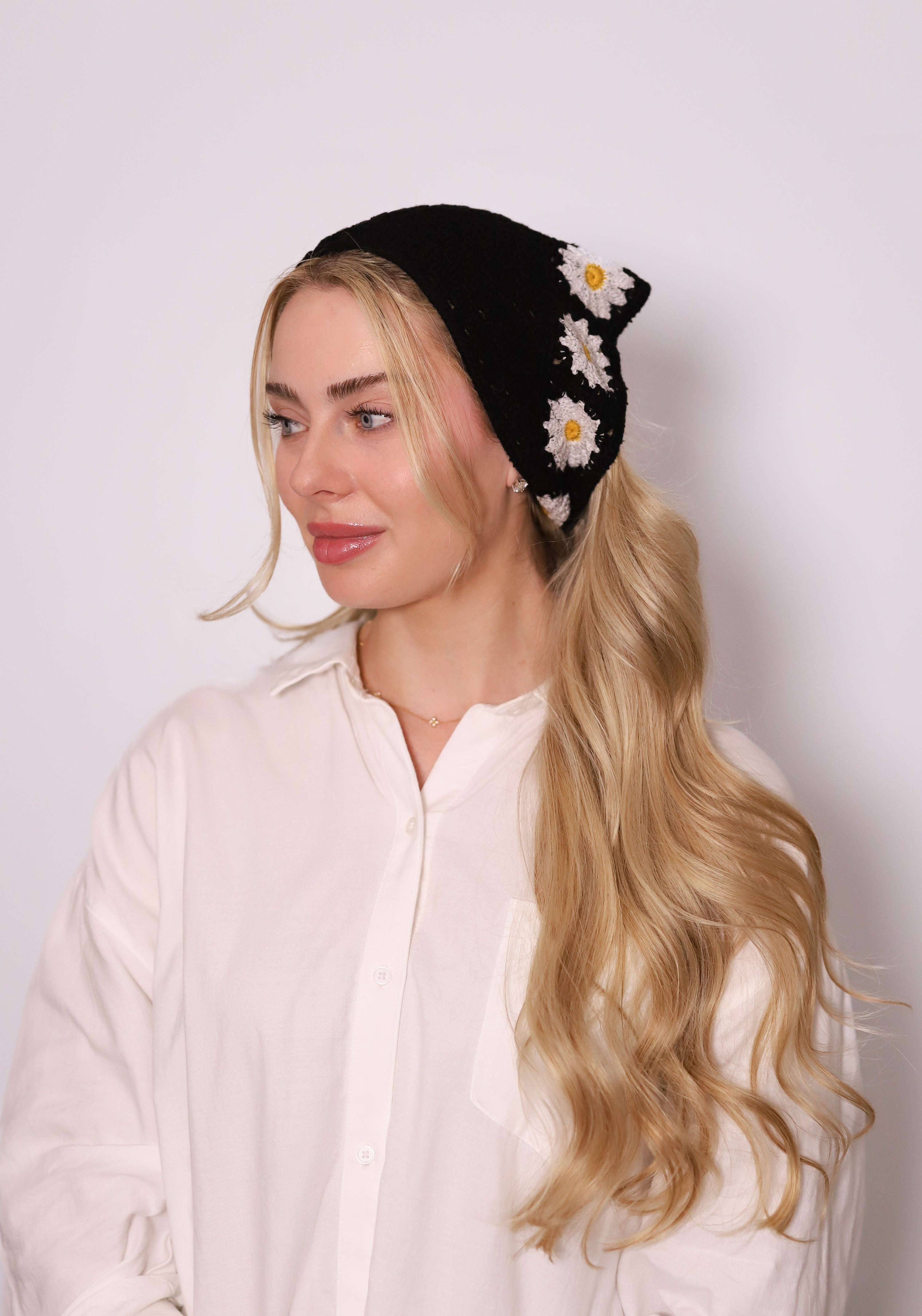 TUK Fleur Crochet Bandana – black crochet headscarf with white daisy flower accents, boho-inspired hair accessory style.
