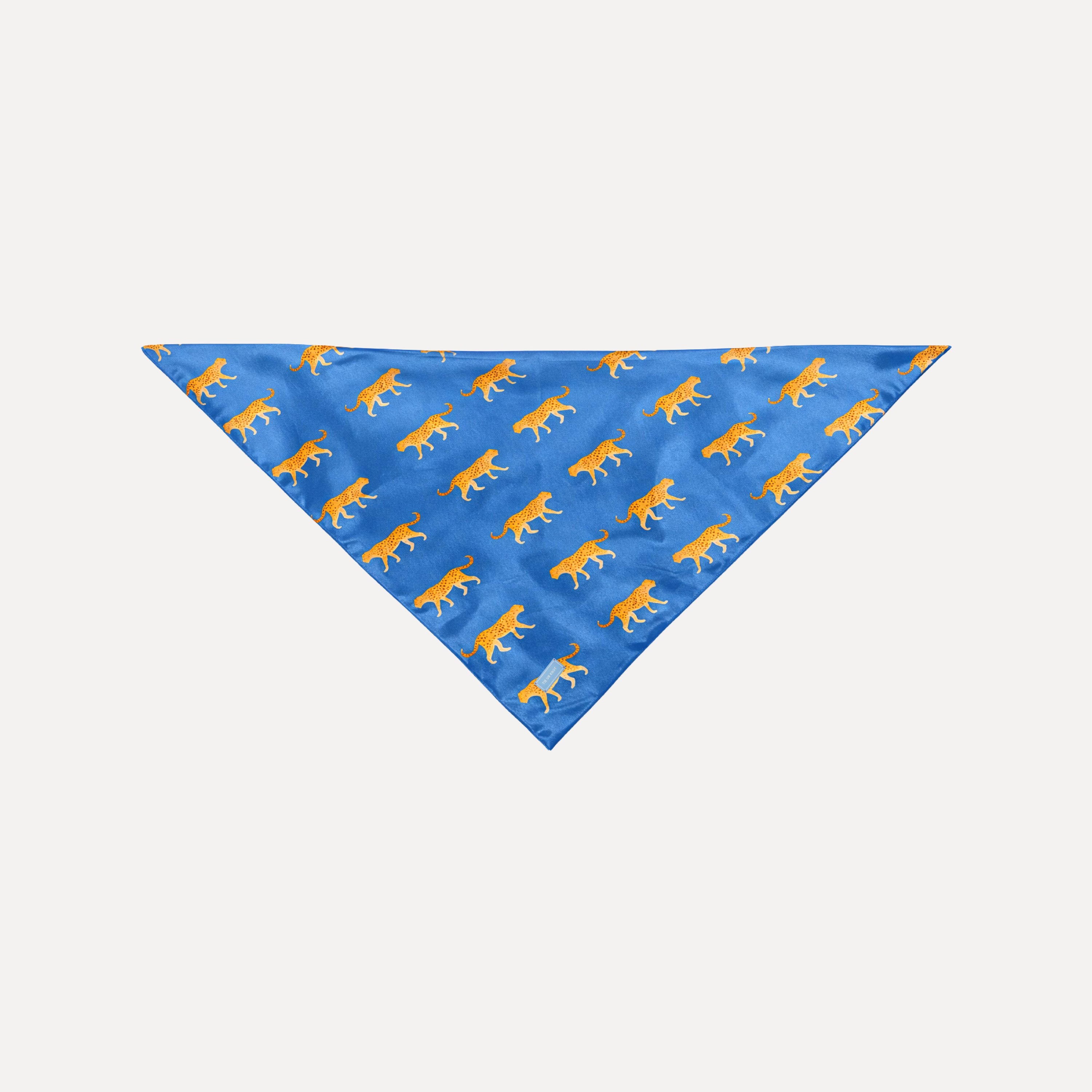 Blue silk scarf with orange cheetah print, luxury Haute Pursuit Silk Scarf by TUK, elegant animal pattern headscarf.