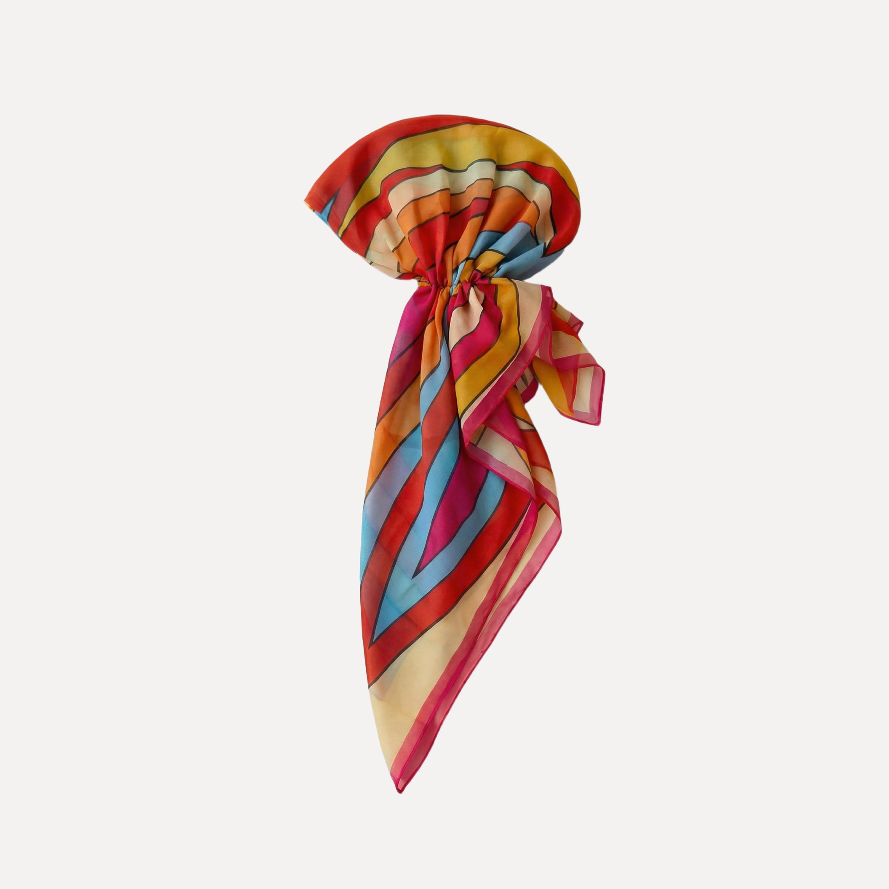 Colorful striped pre-tied headscarf with bold red, orange, blue, and yellow hues, featuring TUK’s Hot Line Head Scarf design.