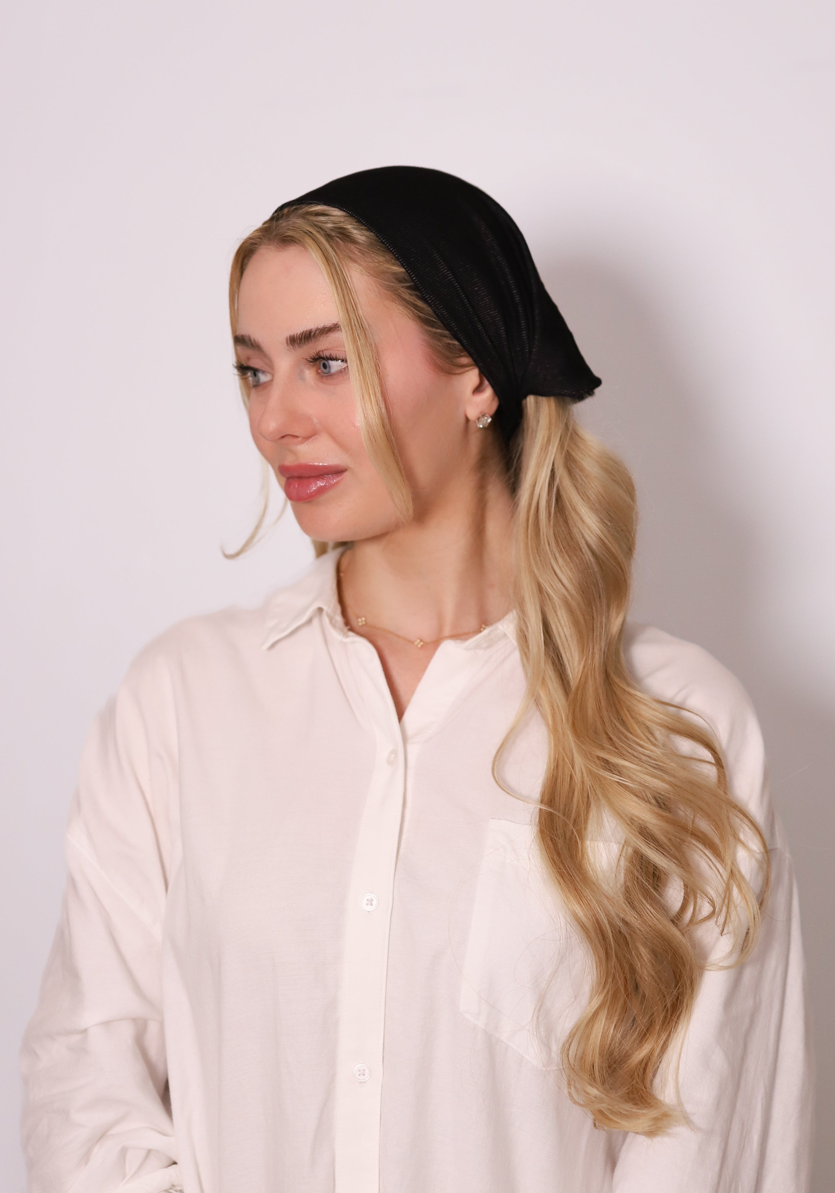 Model wearing TUK Jet Denim Bandana as a black denim headscarf, styled with a sleek, modern and minimalist look.
