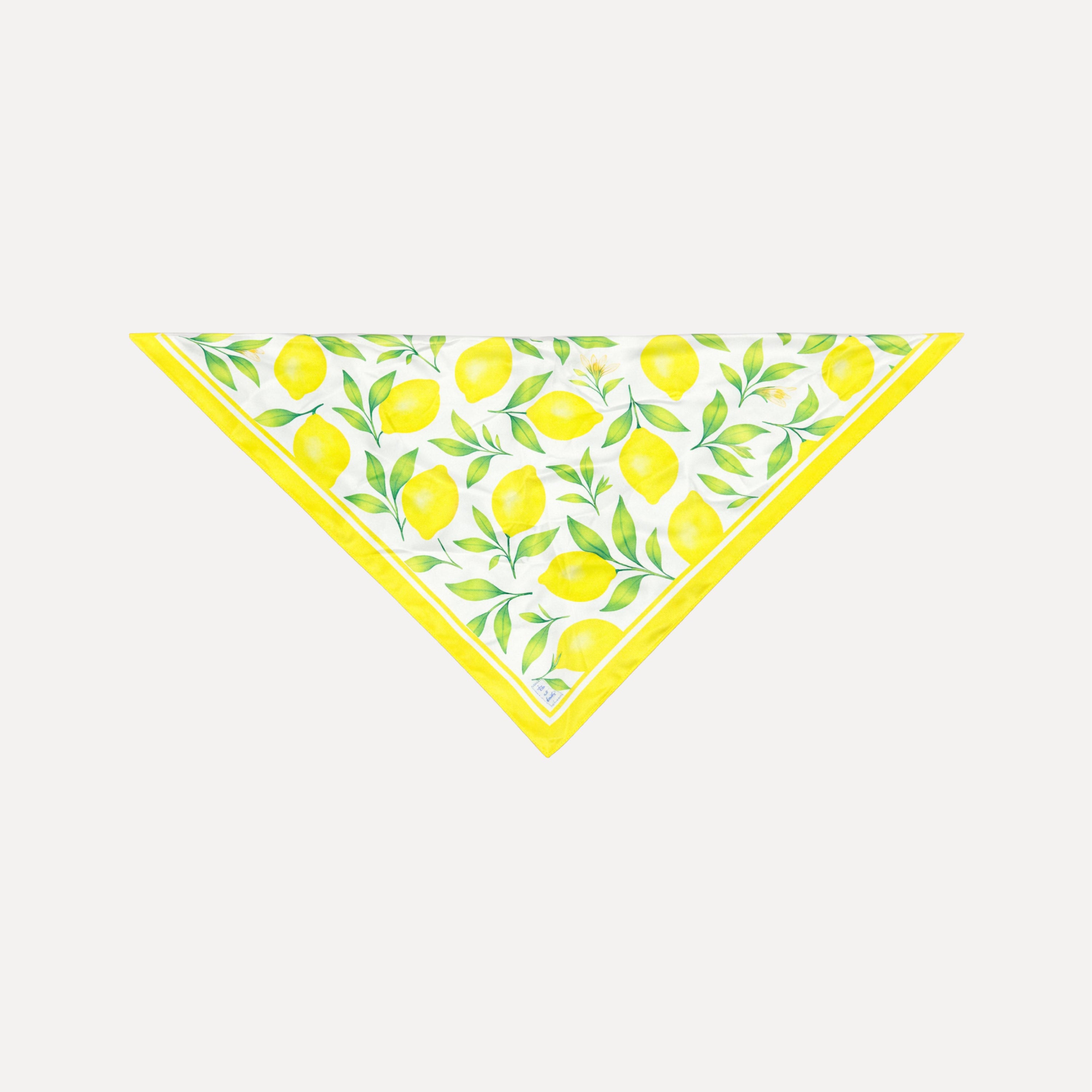 La Limonaia Silk Scarf by TUK featuring yellow lemon and green leaf print on white silk with yellow border, elegant botanical headscarf accessory.