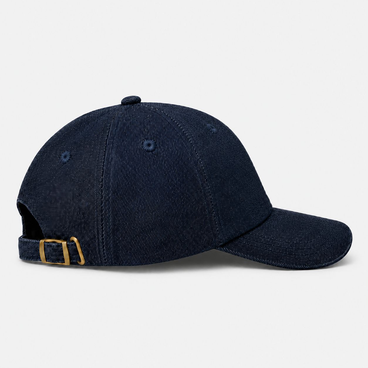 Side view of TUK Medium Wash Denim Cap in premium blue denim with adjustable brass buckle strap and curved baseball brim.