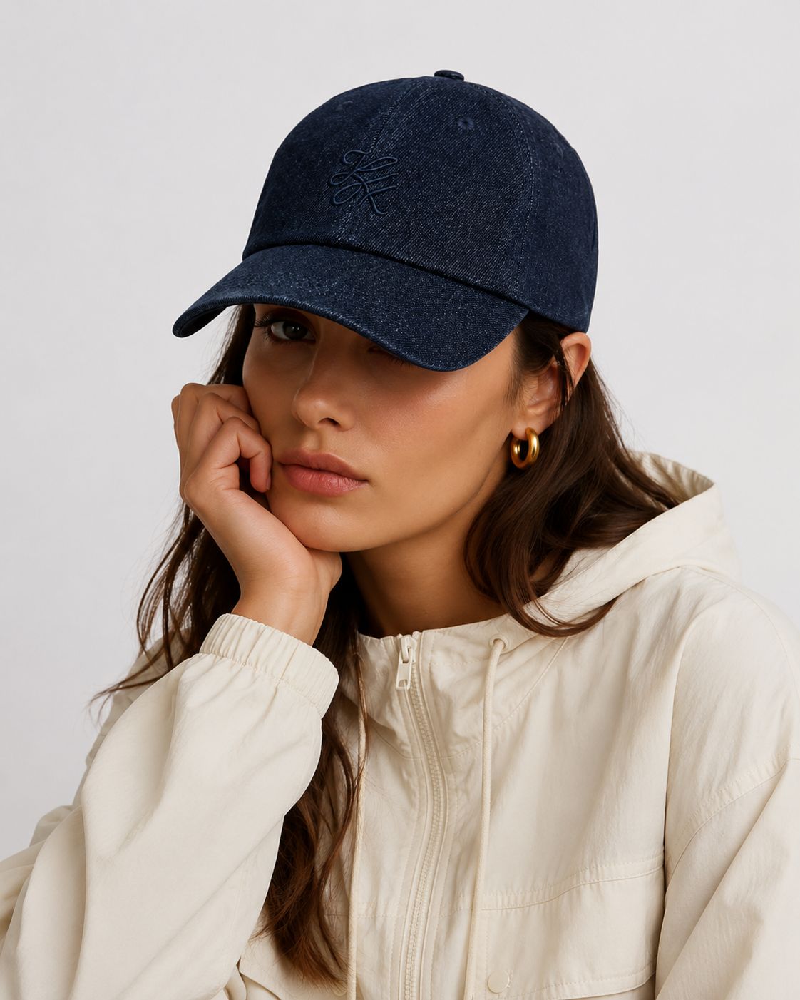 Model wearing TUK Medium Wash Denim Cap in classic blue denim with tonal embroidered logo, curved brim, and casual everyday style.