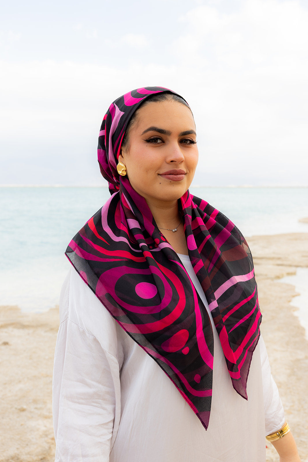 Mind Over Matter Head Scarf by TUK featuring bold pink and black abstract swirl patterns on a lightweight, elegant head scarf design.
