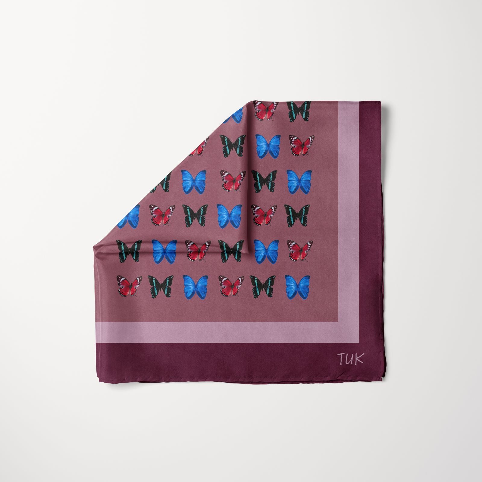 TUK Pattern Pending Head Scarf with bold butterfly print in blue, red, and black on a plum background with modern border design.