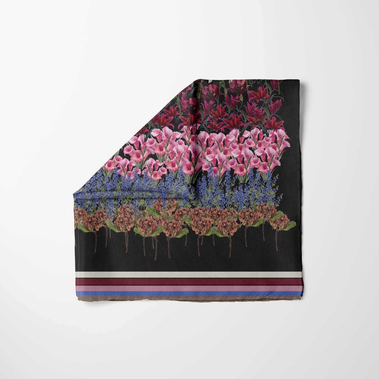 TUK Petal Pusher Head Scarf with layered floral blooms on a black base, accented by bold stripes for a chic, standout accessory.