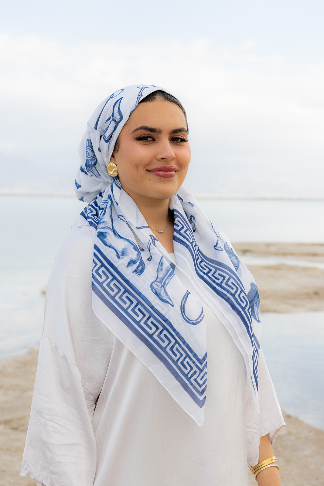 TUK Polo Hour Head Scarf in white and blue equestrian print, styled as a chic head wrap for elegant coastal fashion.