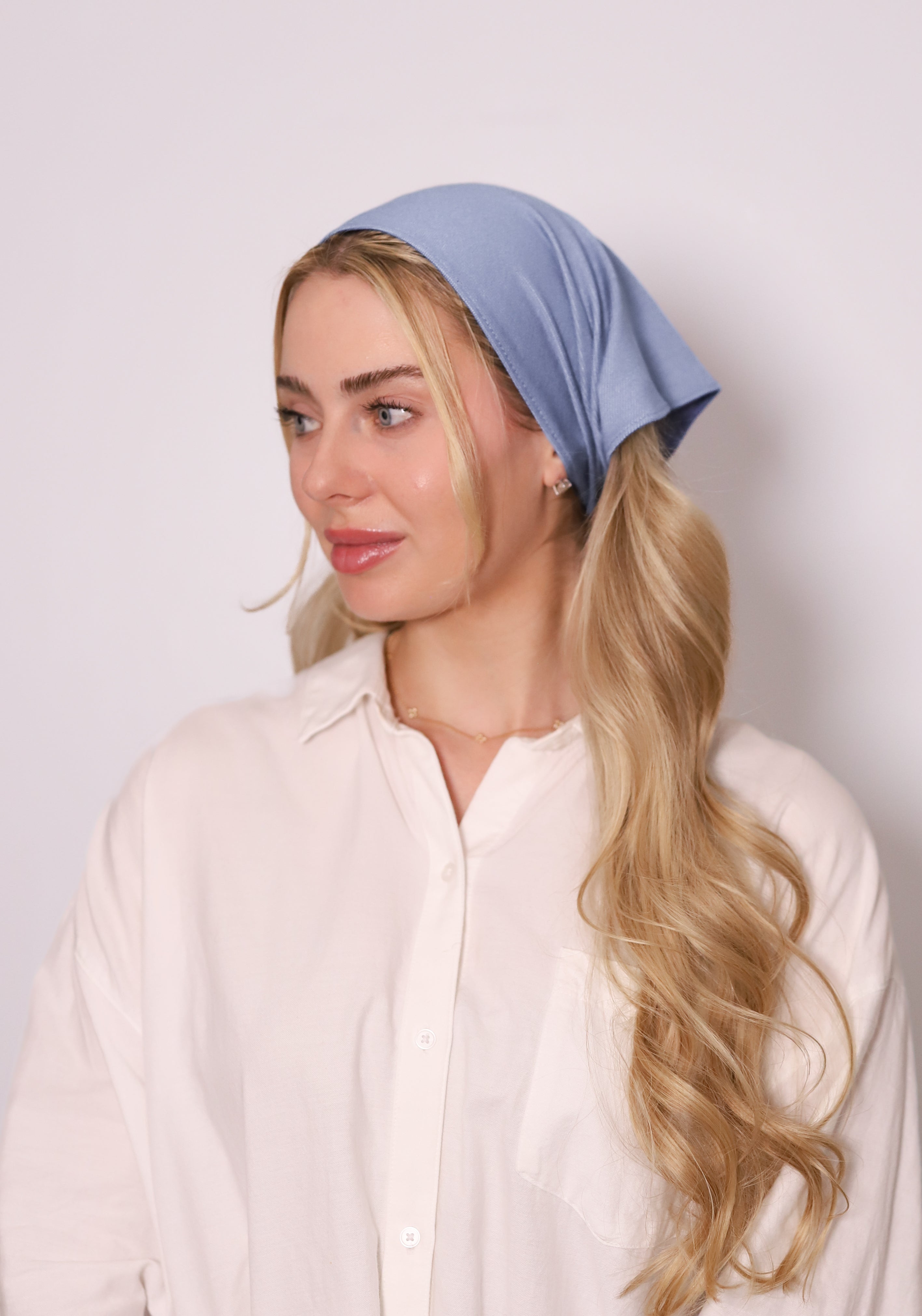 Model wearing TUK Powder Denim Denim Bandana in soft powder-blue denim, styled as a chic headscarf for everyday wear