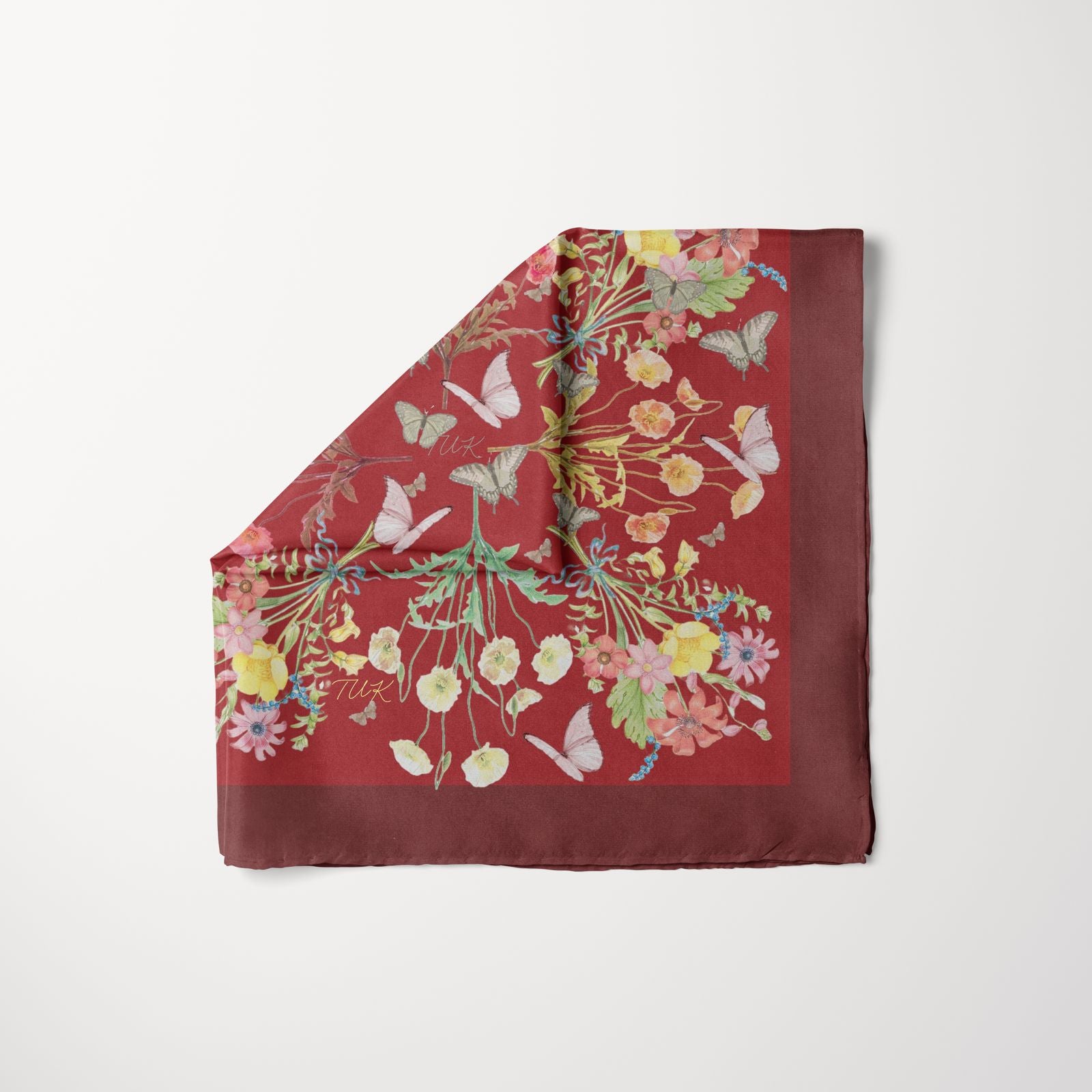 TUK Redacted headscarf in deep red with floral and butterfly print design, luxury silk accessory for elegant fashion styling.