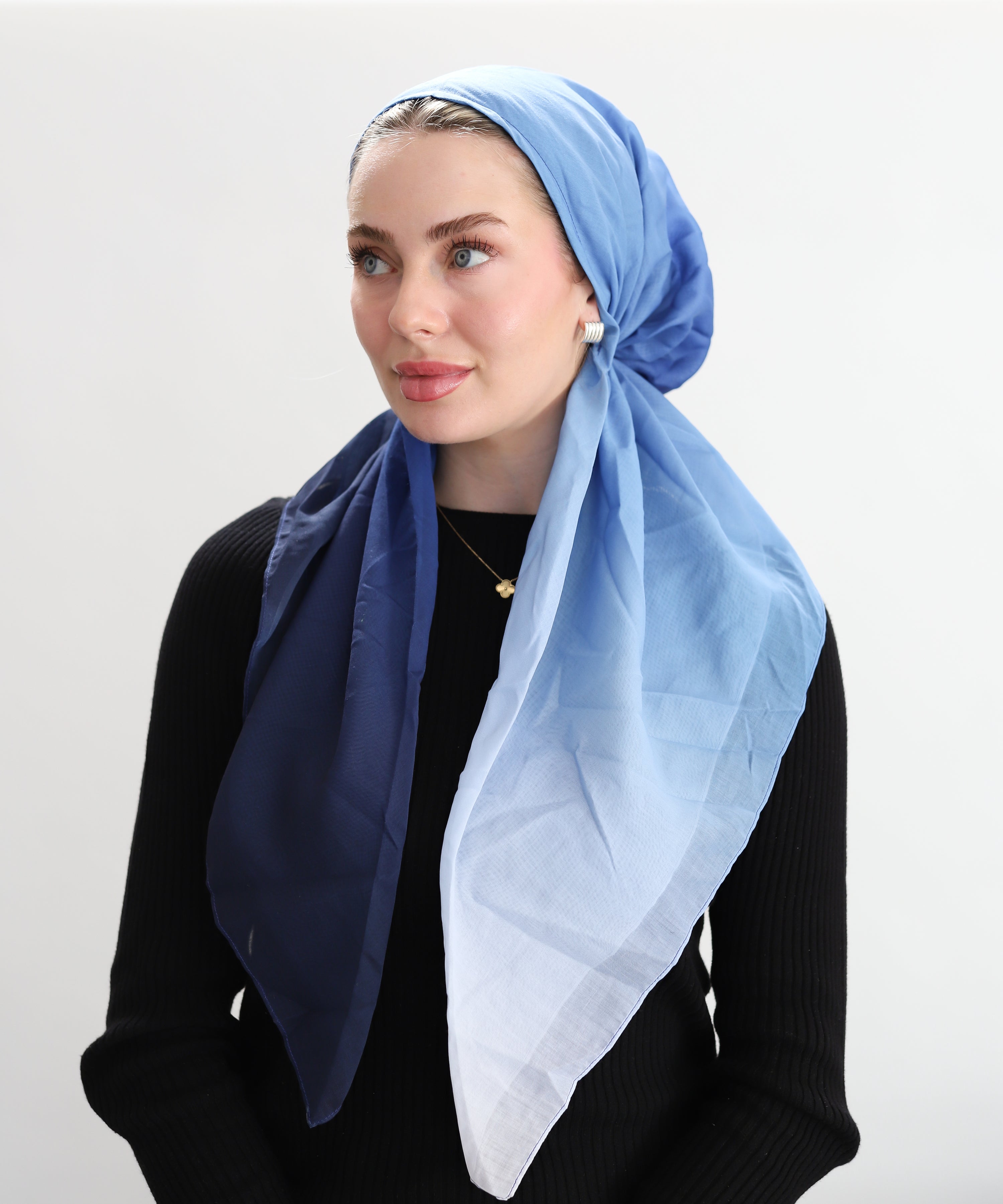 Woman wearing Soft Serve pre-Tied Head Scarf by TUK is your clean blue ombré staple — shifting from lighter winter blues to deeper tones depending on how you tie it.