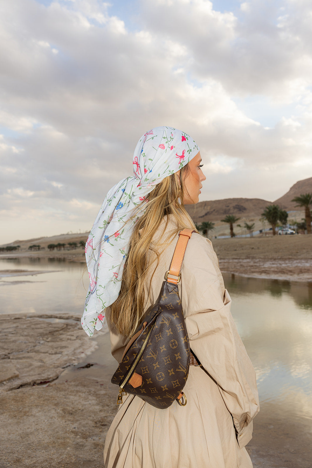 TUK Spring Thing Head Scarf crochet bandana with delicate floral print, styled outdoors by the coast with a flowing back tie.