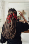 Pink and red flower-print ribbon with black-and-white grid accents