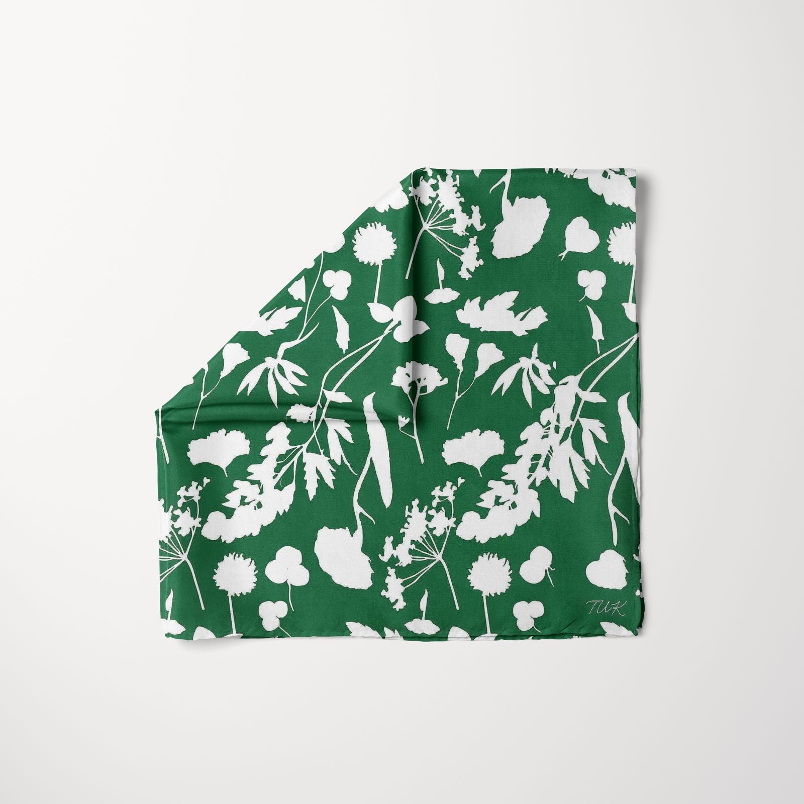 TUK White Noise Head Scarf featuring bold white floral silhouettes on a deep green background, stylish botanical print accessory.