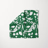 TUK White Noise Head Scarf featuring bold white floral silhouettes on a deep green background, stylish botanical print accessory.