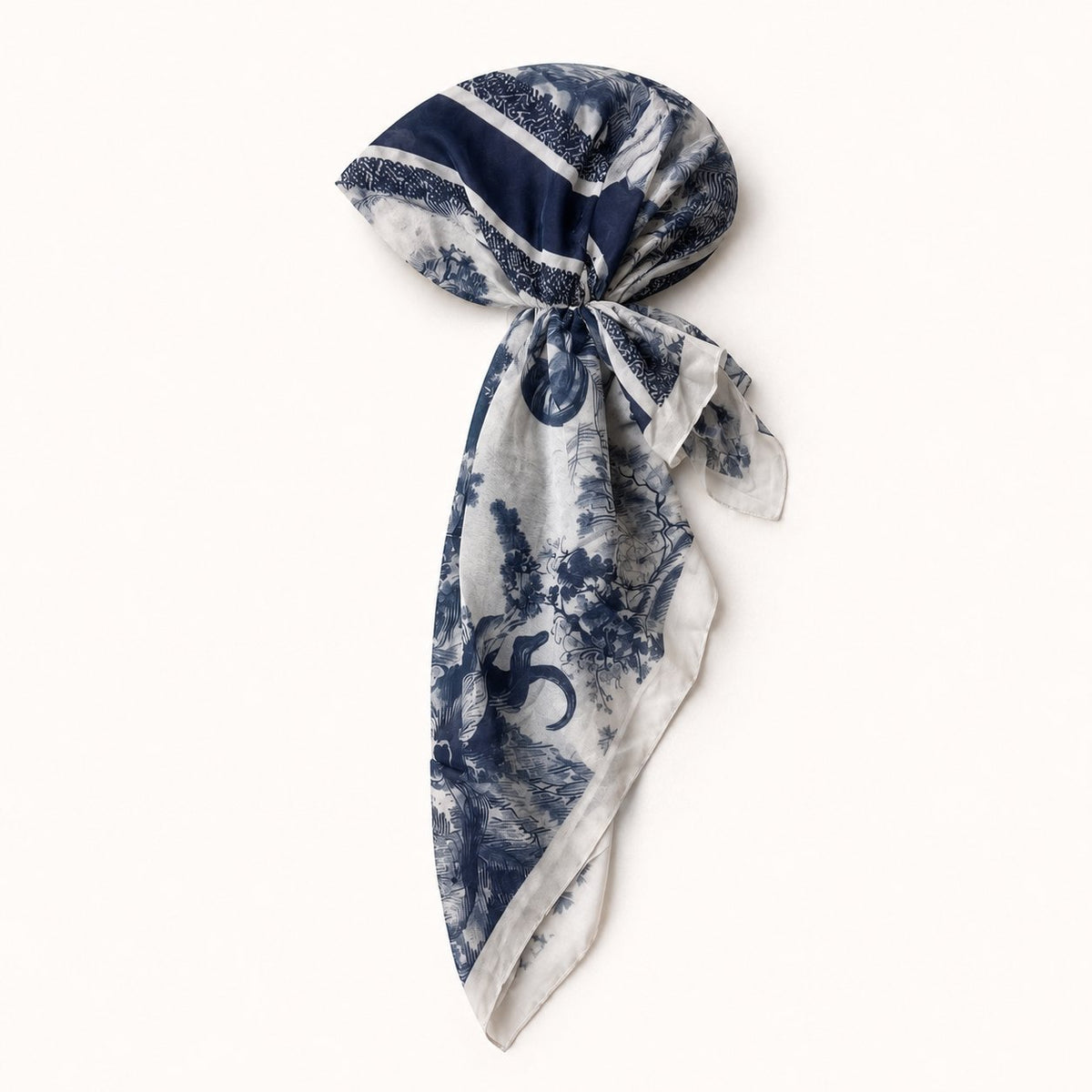 TUK Wild Toile Head Scarf styled in a pre-tied wrap, featuring navy blue wildlife toile, botanical motifs and ivory trim.
