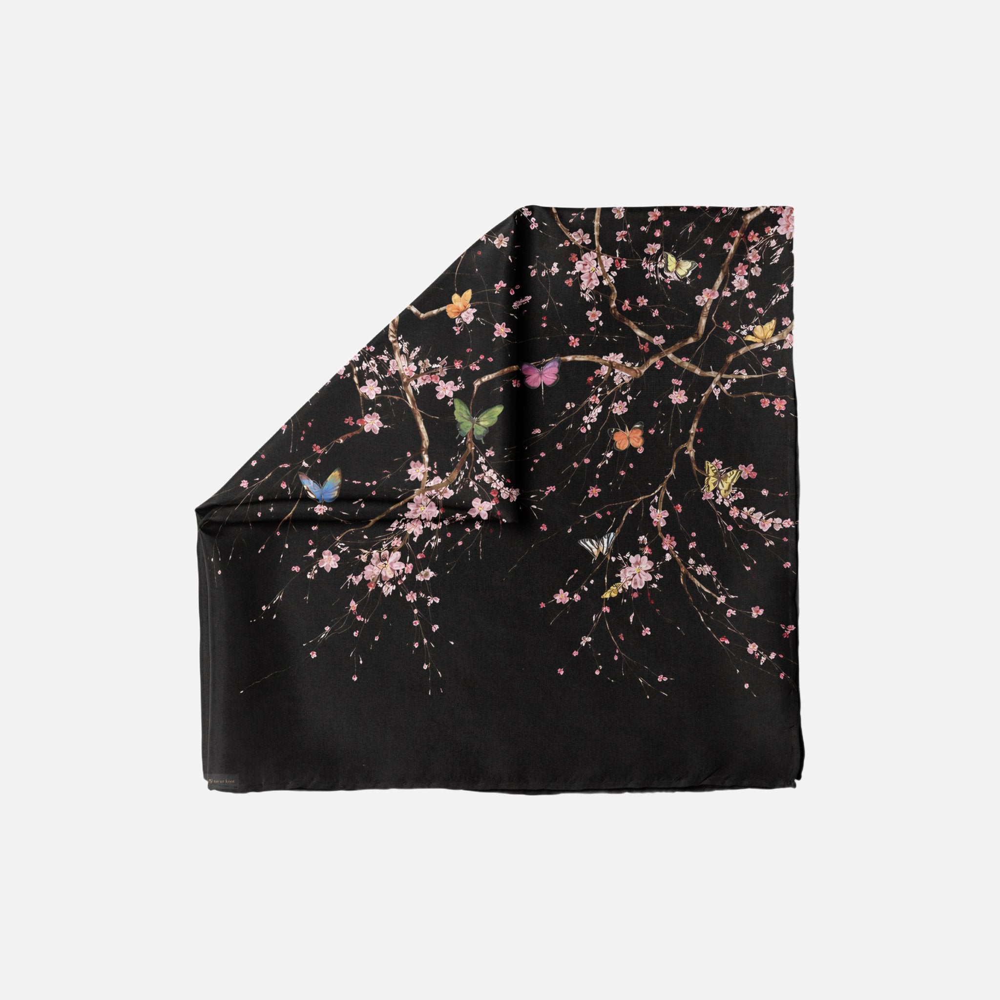 After Bloom Head Scarf. The black scarf features a design of blooming cherry blossom branches with colorful butterflies.