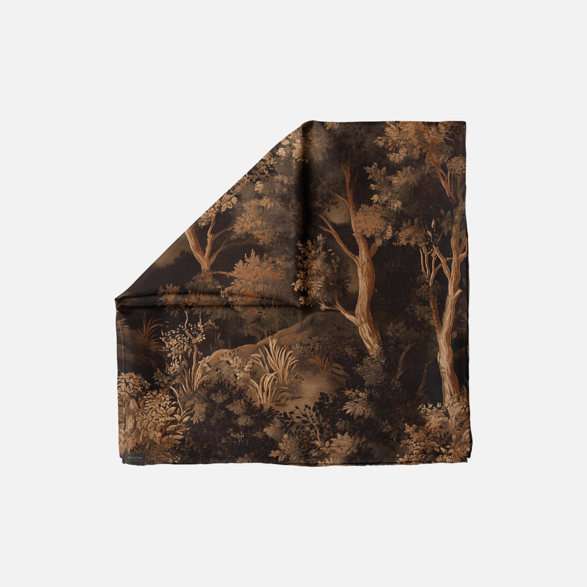 Branch Out Head Scarf with a black and brown forest design. It's folded into a triangular shape.