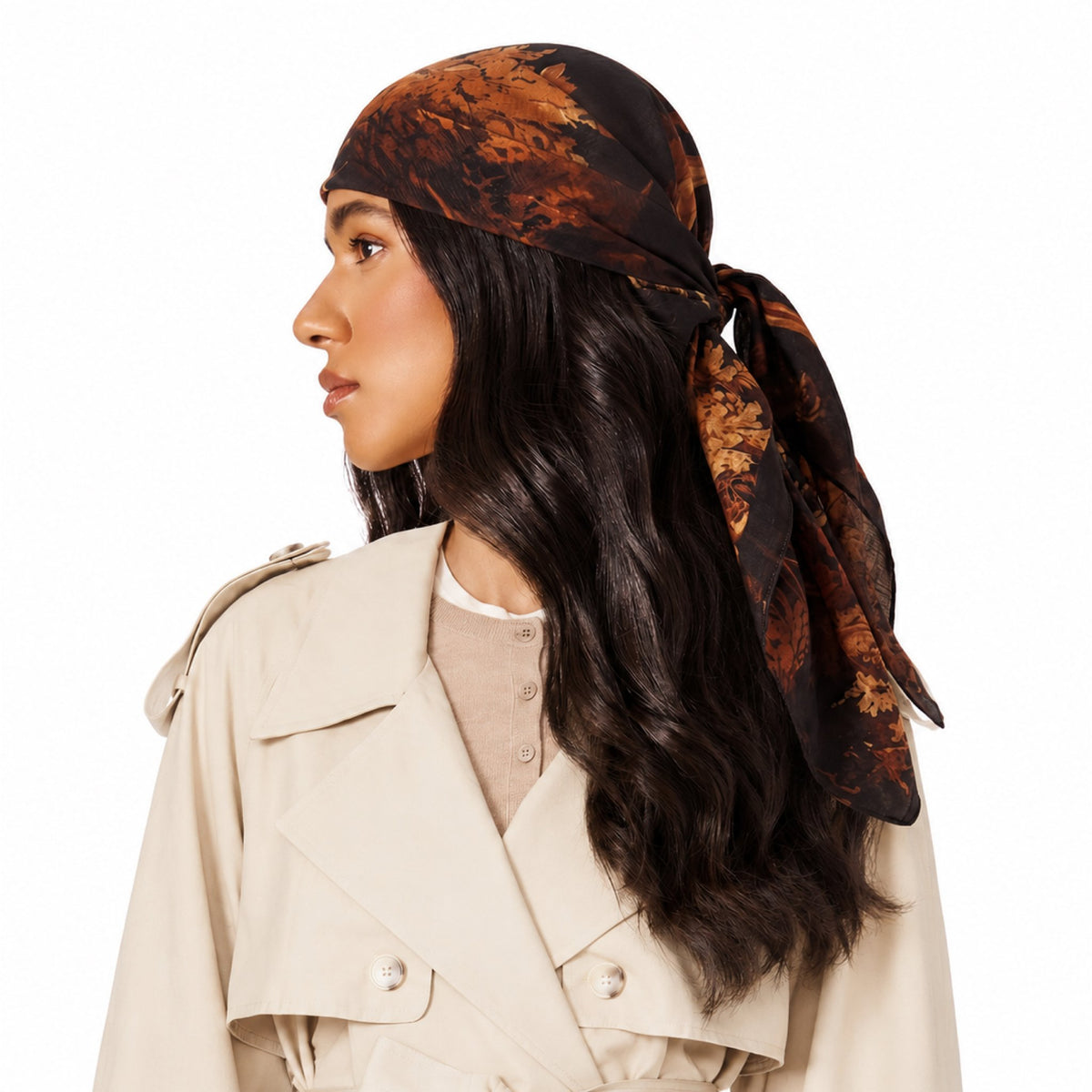 Branch Out Head Scarf worn by a woman with dark hair. The scarf has a black background with a brown, orange, and golden
