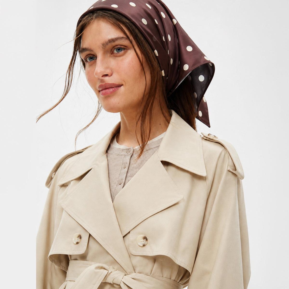 Brown Study Silk Bandana worn by a person, the brown bandana with white polka dots is tied around her head