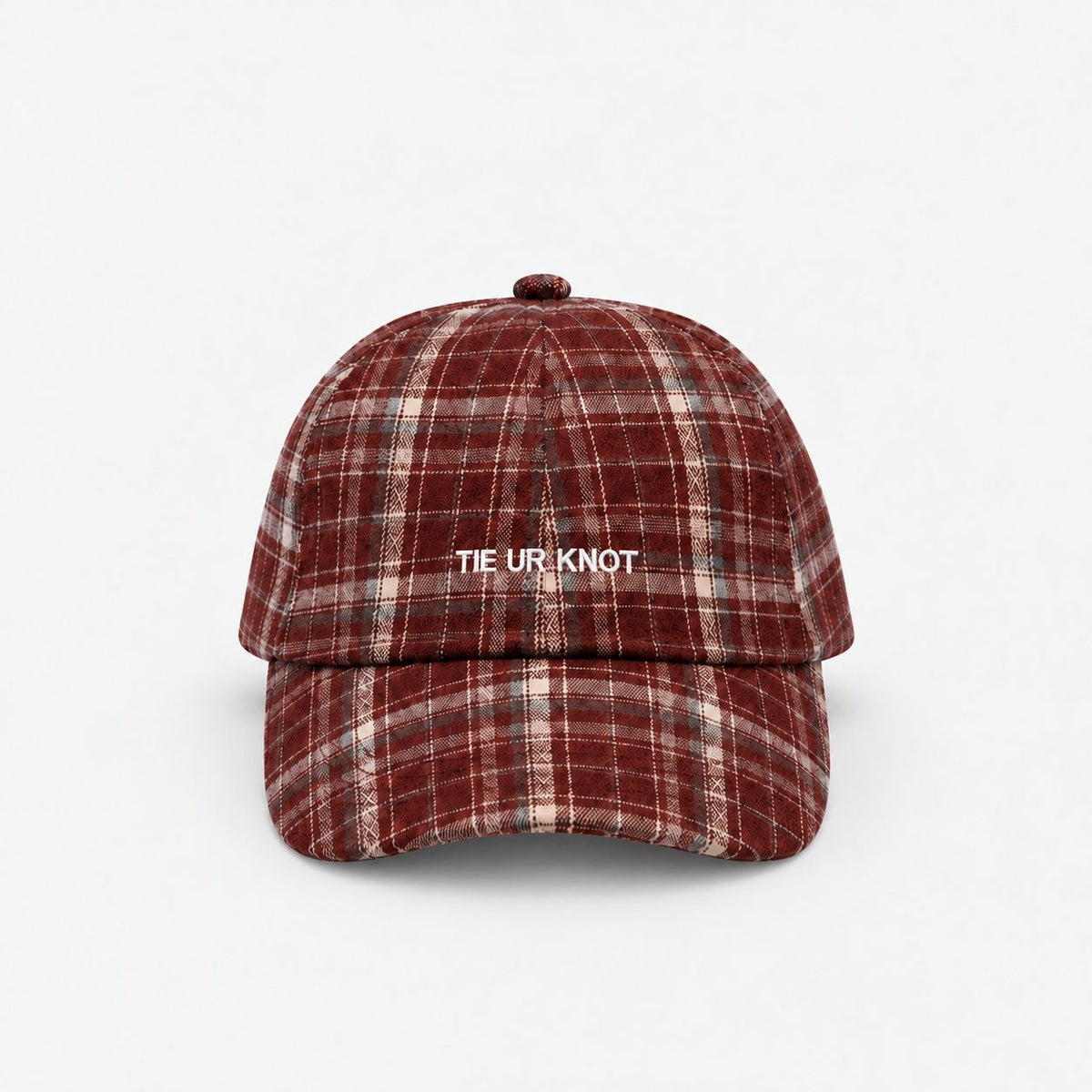 Crimson Check Heritage Plaid Cap by TUK in red and cream plaid with white embroidered Tie Ur Knot logo and curved brim, front view.