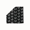 Enchanted Flight Head Scarf featuring a repeating white butterfly pattern on a solid black background, folded with one corner turned down