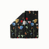 Ethereal Flight Headscarf with vibrant floral and butterfly design on a black background, folded neatly with one corner turned down.