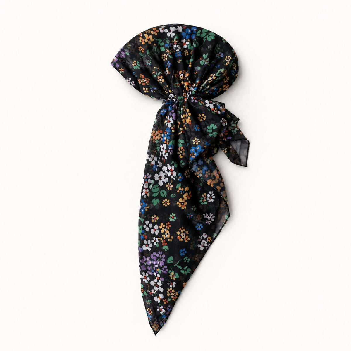 TUK Knot A Wallflower Head Scarf styled in a pre-tied bow, featuring vibrant blue, orange, purple and white florals on black.