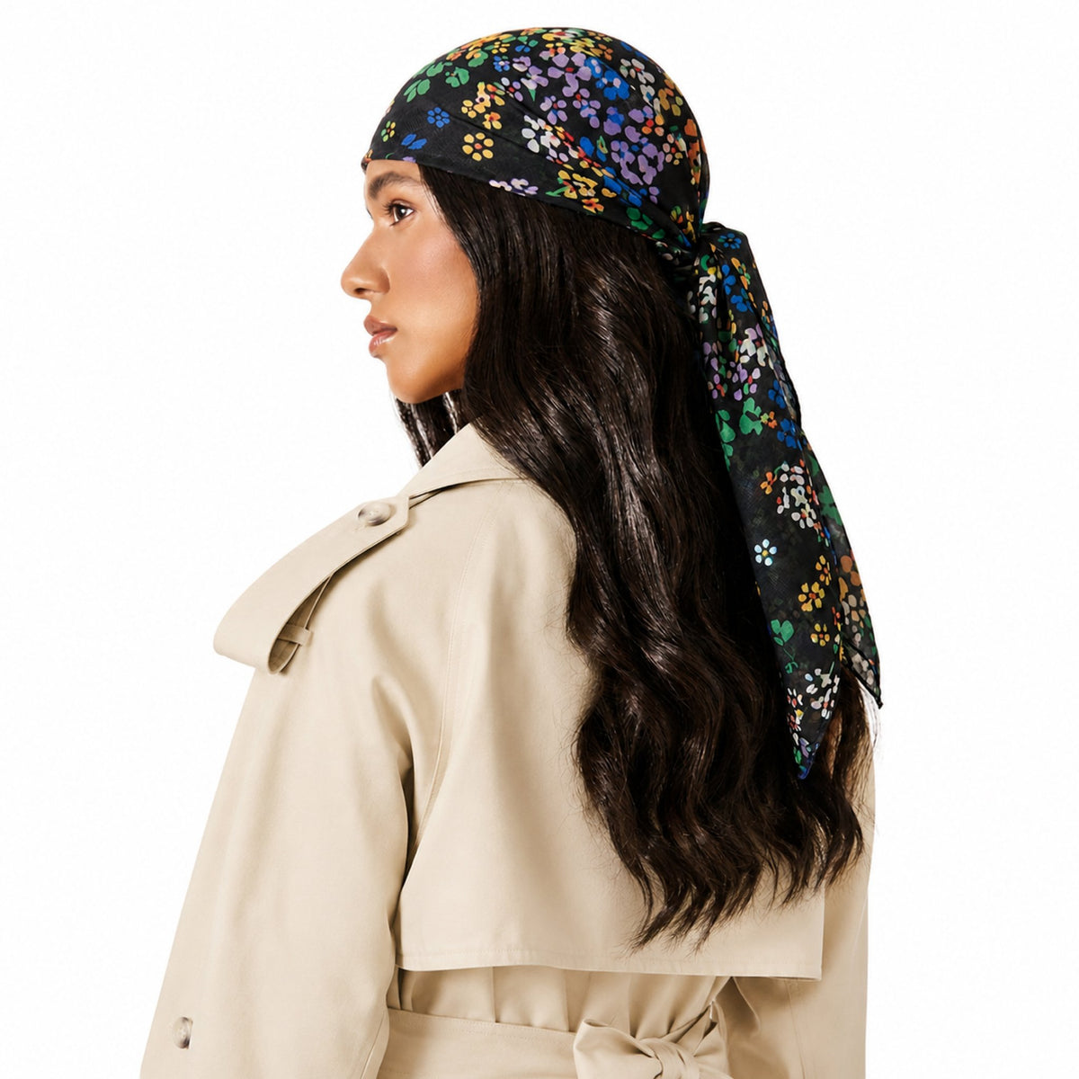 Knot A Wallflower Head Scarf, a black scarf with a scattered multicolored floral pattern, is tied around a person's head.