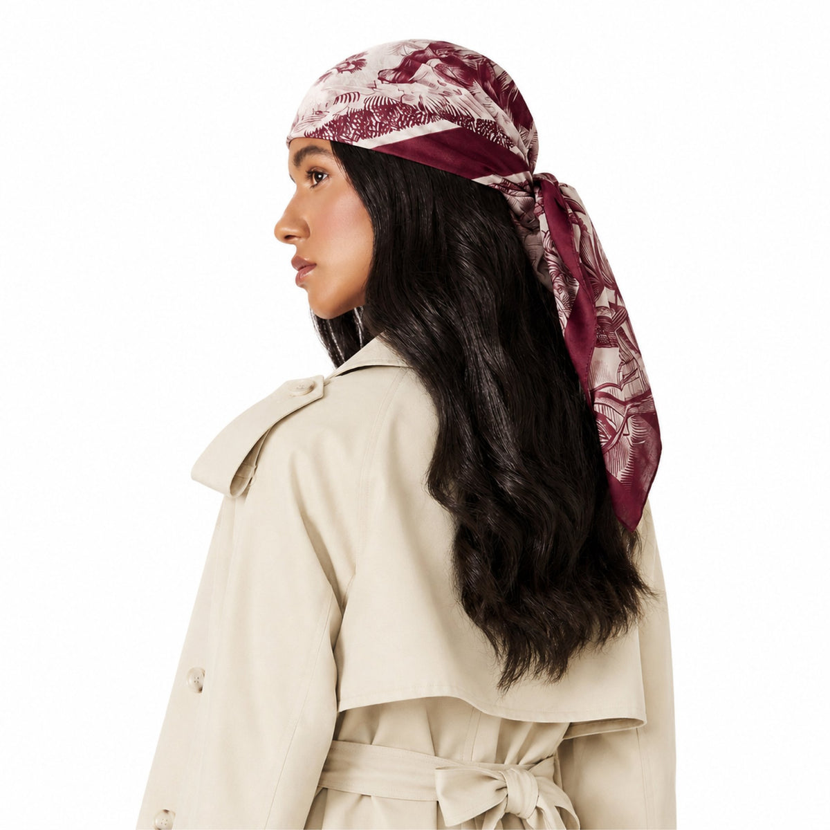 Untamed & Untied Head Scarf. A woman with long dark hair, seen from the back, wearing a white trench coat and a red and